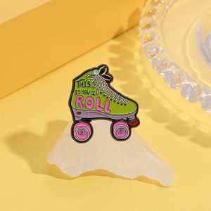 Macro detail of retro green roller skate enamel pin with 'This Is How I Roll' slogan