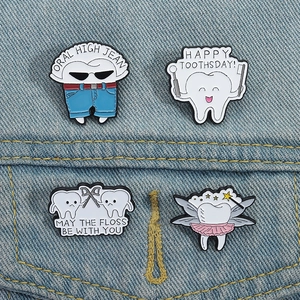 Set of four creative cartoon tooth enamel pins styled on light blue denim jacket