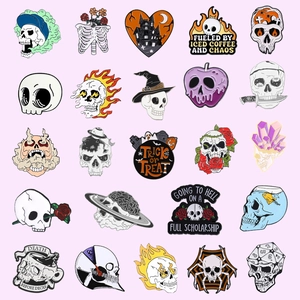25-piece assorted skull enamel pins with Halloween and cosmic motifs on a pink background