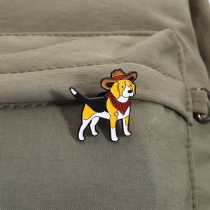Detail of enamel beagle dog pin with cowboy hat on a green backpack strap