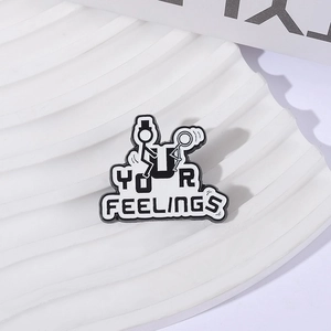 Minimalist Your Feelings enamel pin with funny stick figure design on white stone display