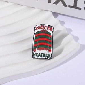 Enamel brooch with Freddy Krueger red and green striped sweater and Sweater Weather text