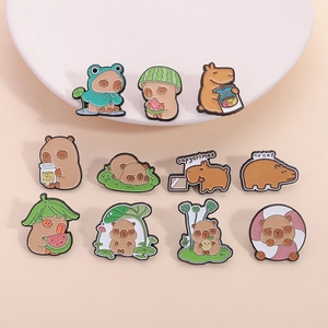 Set of 11 cute cartoon capybara enamel pins with various fun outfits and text on a round base