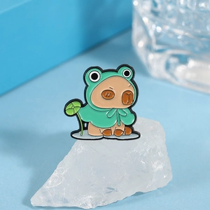 Cute capybara enamel pin wearing frog raincoat and holding a green lotus leaf