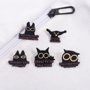 Funny black cat enamel pins with humorous slogans on white canvas bag background