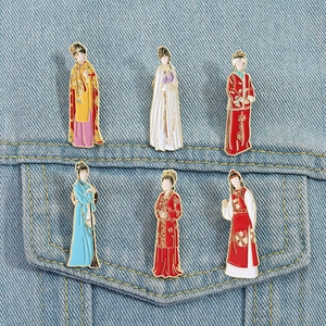 Detail view of six colorful enamel brooches featuring traditional Hanfu clothing on denim