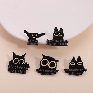 Five-piece black and gold cat enamel pin set with humorous quotes on a white display stand