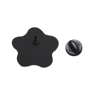 Detail view of the black metal star brooch back pin with a secure rubber clutch back
