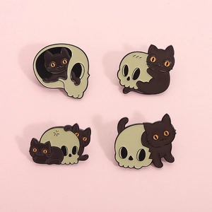 Set of four Halloween enamel pins featuring cartoon black cats and skull motifs on pink