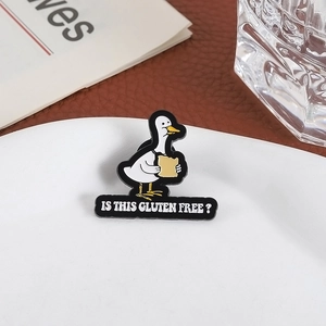 Funny white duck and bread enamel pin with 'Is this gluten free?' text for bags
