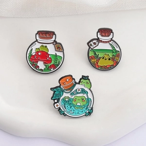Three creative frog drift bottle enamel pins with mushroom and star moon designs