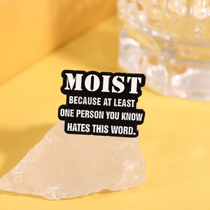 Black rectangle brooch with humorous English quote Moist text on mineral stone