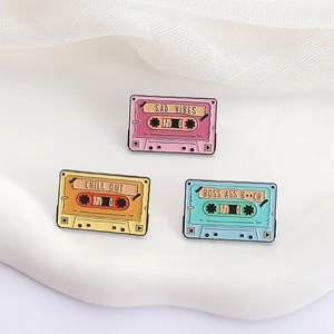 Detailed macro view of colorful retro enamel tape pins featuring aesthetic English slogans