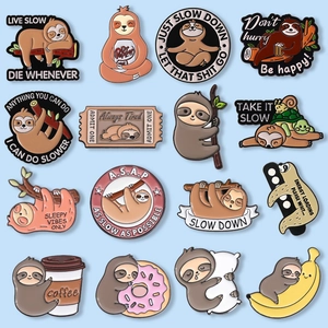 Macro display of sixteen diverse enamel sloth badges with humorous English phrases