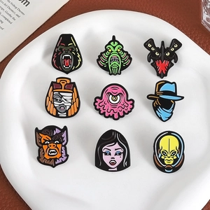 Set of 9 colorful monster enamel pins featuring gorilla and vampire on a white plate
