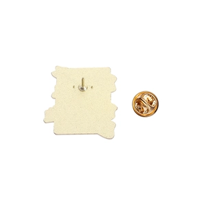 Detail view of the golden metal alloy skull pin back with secure butterfly clutch