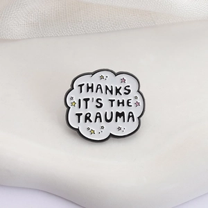 Cloud-shaped enamel pin with 'Thanks It's The Trauma' text and colorful stars