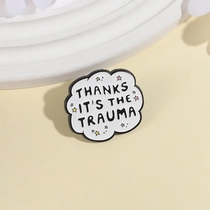 Cloud-shaped enamel brooch with Thanks It's The Trauma quote and star accents