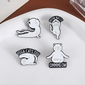 Set of four cute cartoon white yoga cat enamel pins with creative yoga poses on a plate