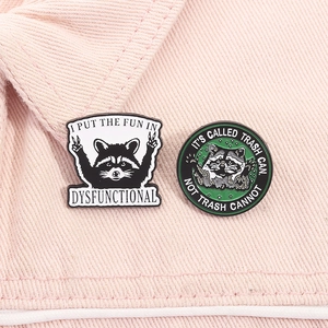 Detail of funny enamel pins with raccoon illustrations and humorous English slogans
