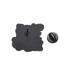 Detail of the black matte enamel pin back featuring the metal needle and butterfly clutch