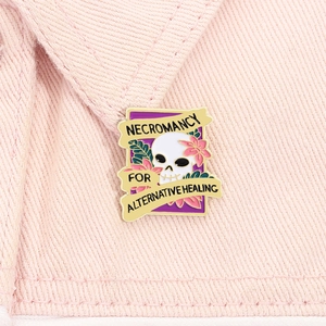 Detailed view of skull enamel pin with pink flowers on pink denim jacket pocket
