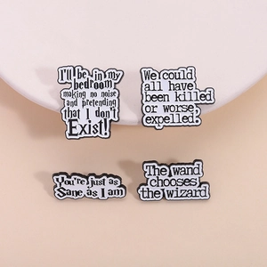 Set of four black enamel pins featuring inspirational white quotes for jacket lapels