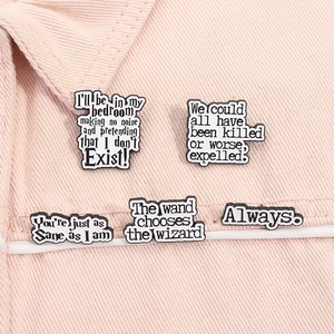 Macro view of five Harry Potter enamel pins with classic quotes on pink denim fabric