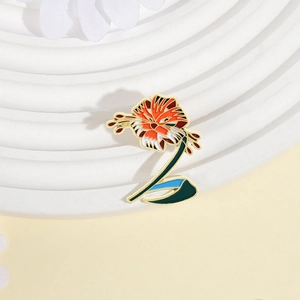 Tiger lily enamel pin with floral stripes and golden metal edges on a white display