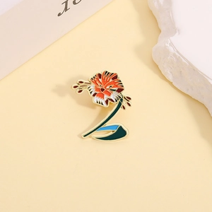 Artistic tiger lily enamel pin with orange floral stripes on a soft yellow background
