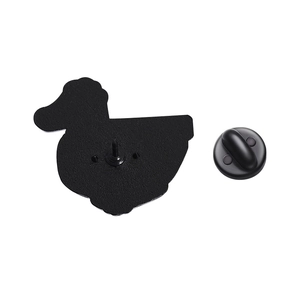 Detailed macro view of the metal duck brooch back with a black rubber clutch pin back