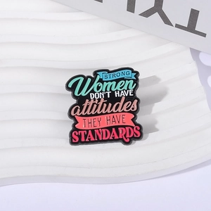 Enamel pin with 'Strong Women Have Standards' quote on white textured background