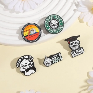 Set of 5 Karl Marx enamel pins with humorous slogans on white corrugated display board