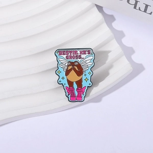 Quirky brown frog fairy enamel pin with wings and pink boots on a white wavy stand