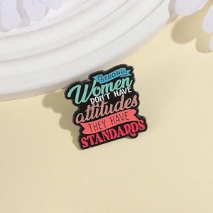 Enamel pin featuring colorful 'Strong Women Have Standards' quote on black alloy metal