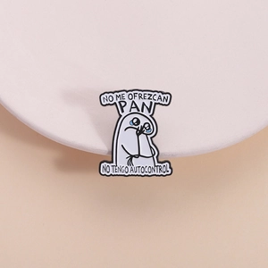 Macro detail of Flork enamel pin with Spanish text No Me Ofrezcan Pan on a warm background