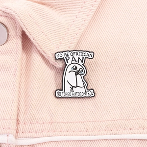 Detail of Flork enamel pin with Spanish text on pink denim fabric showing texture
