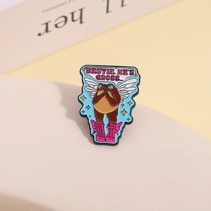 Detail of frog fairy enamel pin with pink boots and funny quote on beige background