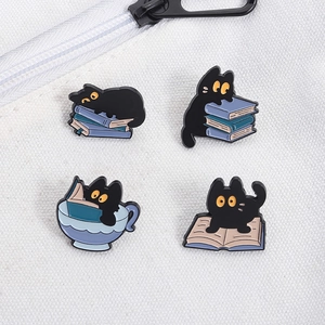 Set of four cartoon black cat enamel pins pinned on a white canvas texture bag detail