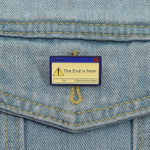 Vintage computer error box enamel pin with The End is Near text on denim jacket