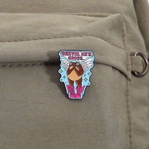 Close-up of a funny frog badge with wings pinned to a backpack as a unique accessory