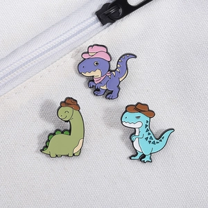 Detail of colorful dinosaur enamel pins set on a canvas bag showing craft and texture