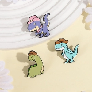Three-piece set of cartoon dinosaur enamel pins featuring colorful cowboy hat designs