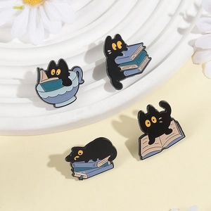 Set of four cute black cat enamel pins with books for backpacks and clothing decoration