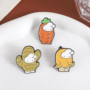 Cute enamel pins set with white characters in carrot and fruit outfits on ceramic plate