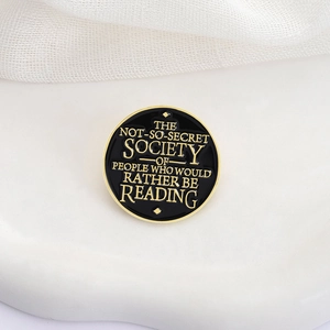Enamel pin with text 'The Not-So-Secret Society Of People Who Would Rather Be Reading'