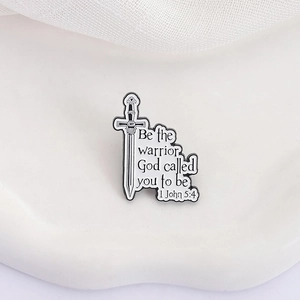 Minimalist sword enamel brooch with 1 John 5:4 scripture in black and white finish