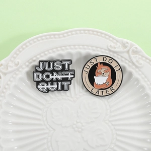 Cute sloth enamel pins set with inspirational quotes on a white decorative ceramic plate