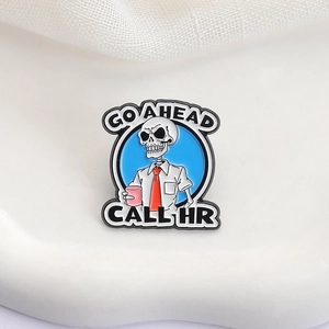 Funny skeleton enamel pin in white shirt with 'Go Ahead Call HR' text for office humor