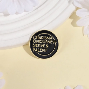 Minimalist enamel pin featuring golden text on black background with white flower backdrop